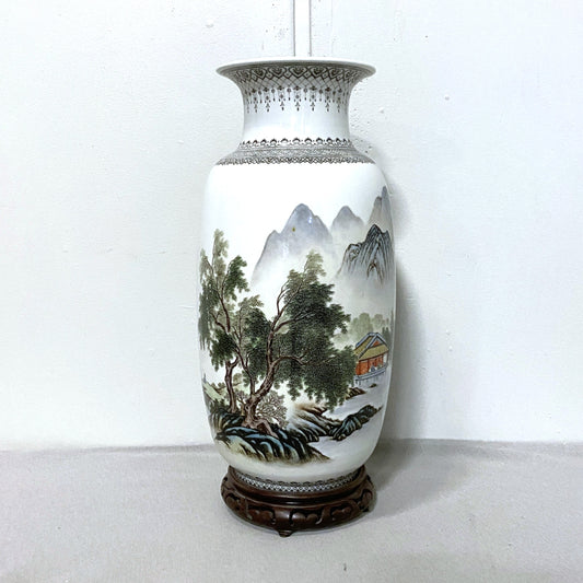Decorative vase with a landscape design on a white background