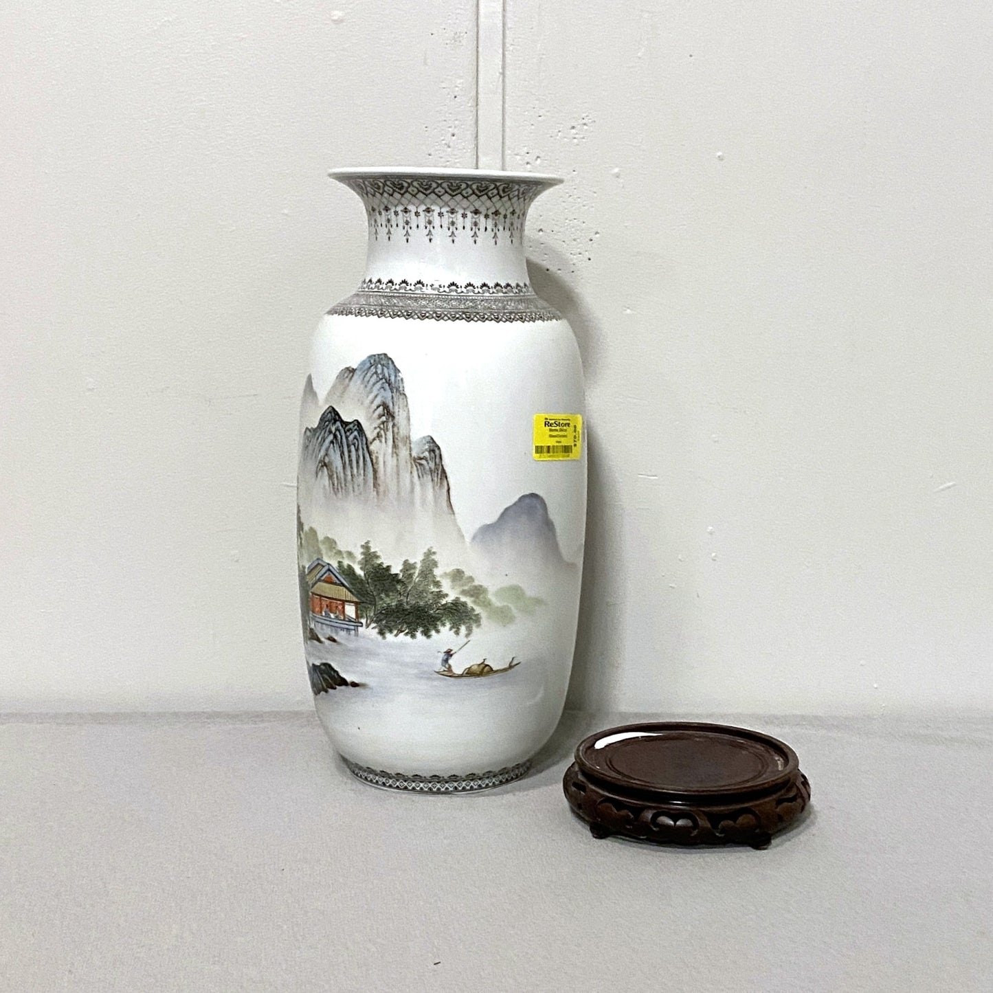 Decorative vase with mountain landscape design on a white background