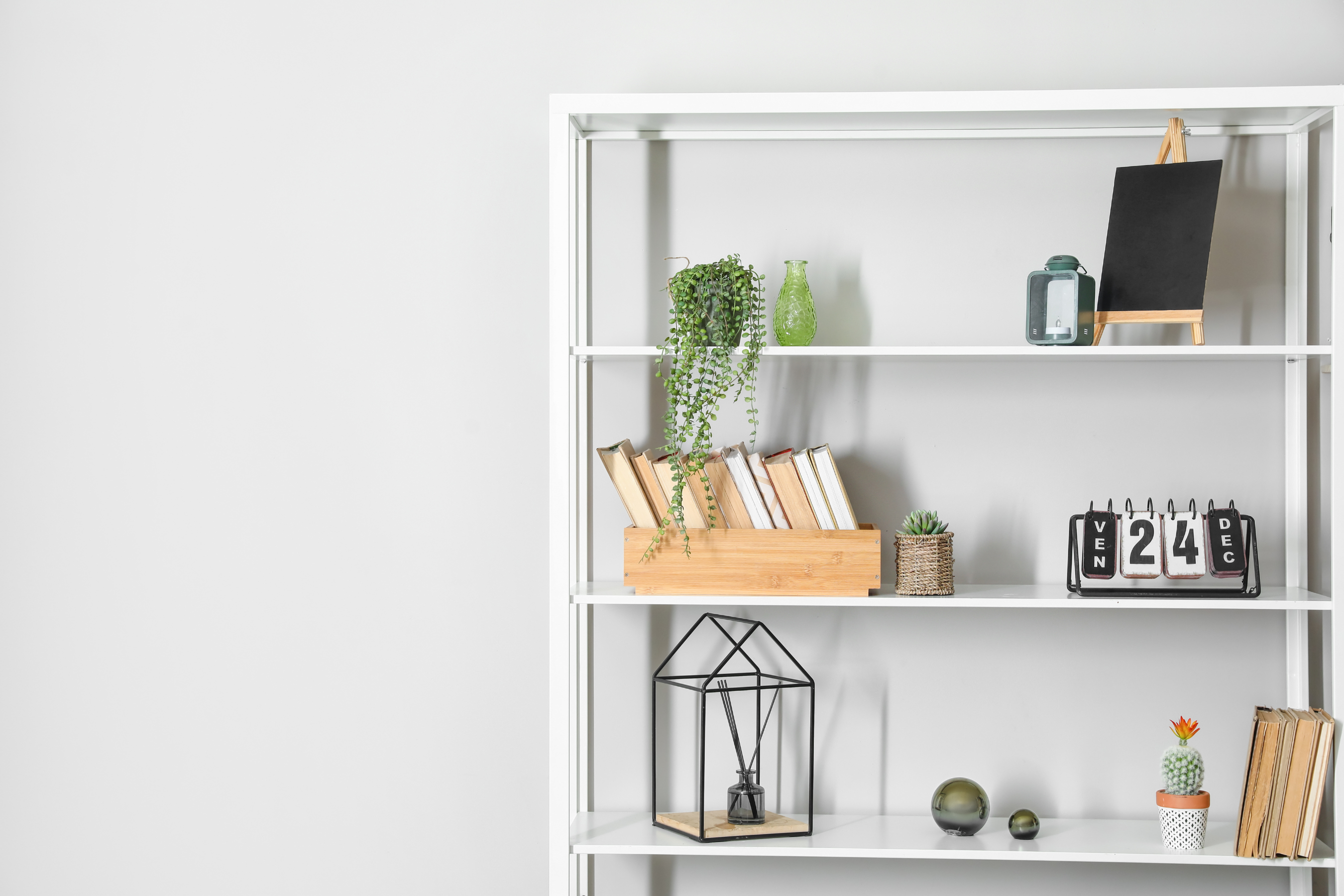 white shelf with various modern and vintage home decor items styled